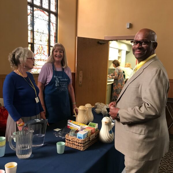 3 people standing together about to serve food